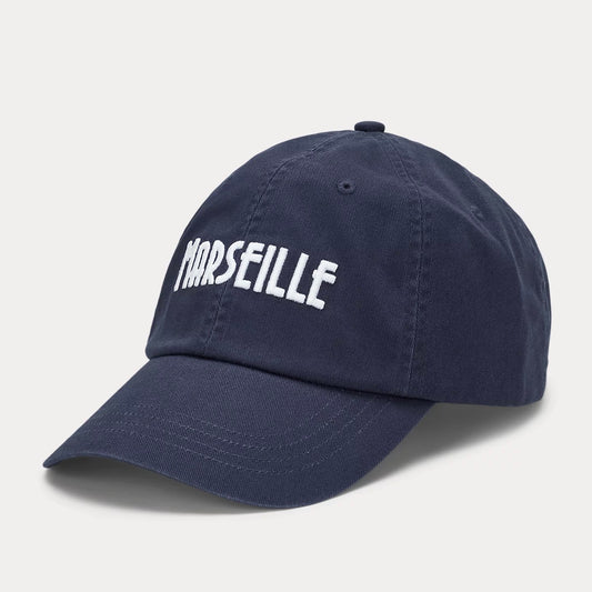 On this cotton twill ball cap, Art Deco-inspired embroidery outlines the name of the French seaside city of Marseille.