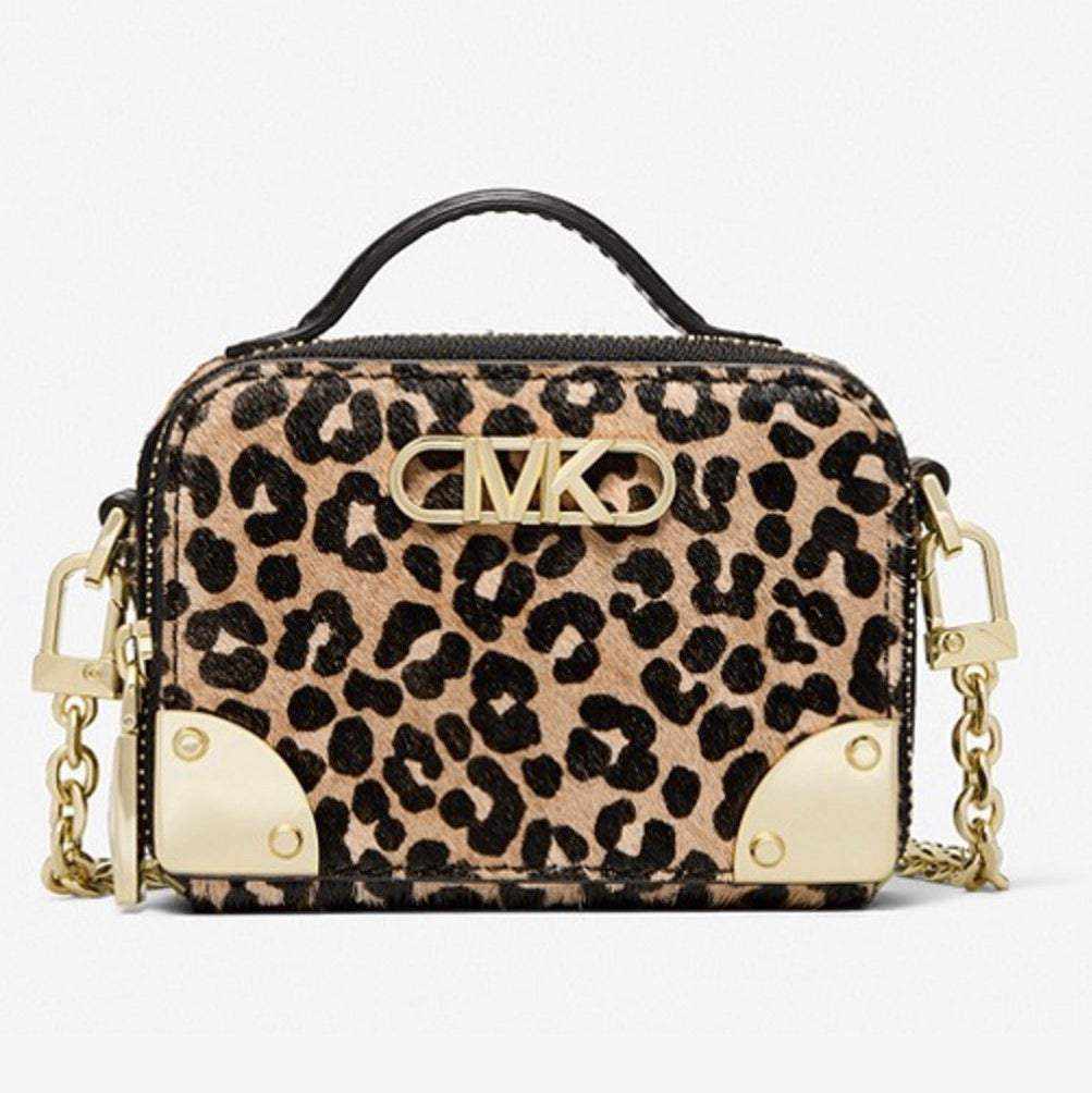 With a structured silhouette inspired by vintage trunks, we shrunk our classic Estelle down to make the perfect night-out bag. A zipper closure opens to an interior with three inner compartments to keep you organized on the go. Crafted from leopard-print calf hair and finished with gold-tone hardware, it includes both a top handle and chain-link strap for multiple carrying options.