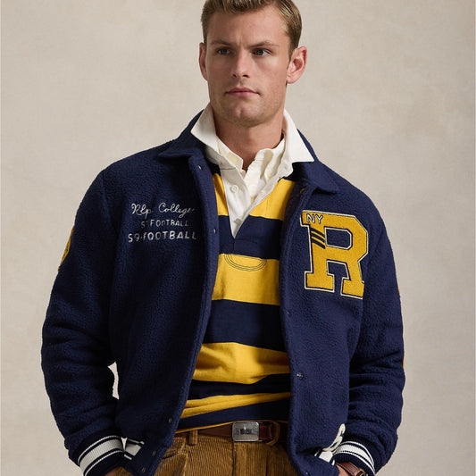 Crafted with curly pile fleece, this layer draws inspiration from classic letterman jackets, incorporating signature and varsity-inspired graphics.