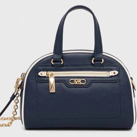 This mini-sized version of the Williamsburg bag features pebbled leather punctuated with contrasting trim and gold-tone hardware. The beauty lies in its versatility—it can be carried hands-free with the help of the chain-link strap, or in hand by the top handles. It’s perfect for so many occasions, day or night.