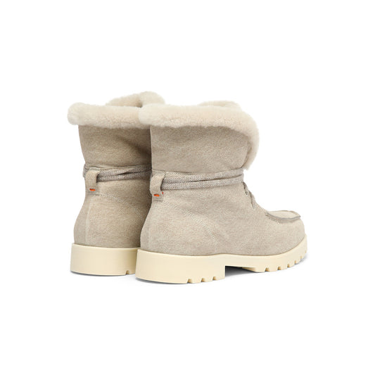 Mountain air meets luxurious allure and artisanal details. This refined take on the classic hiking boot is crafted from suede and lined in cosy fur, providing maximum warmth during the colder months. Functional yet feminine, its silhouette combines timeless apron stitching with a robust rubber sole.